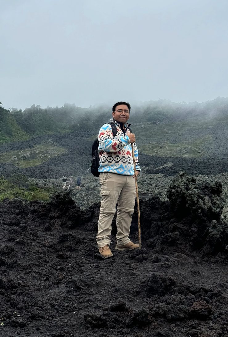 Tony standing on volcanic rock in the mist